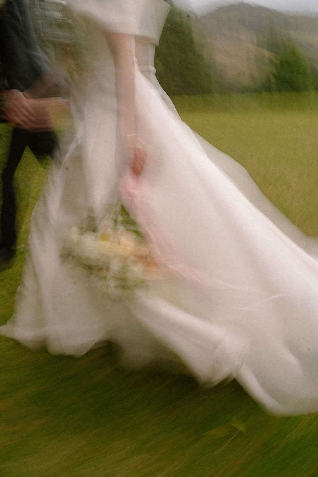 Artistic motion blur of bride walking in wedding dress