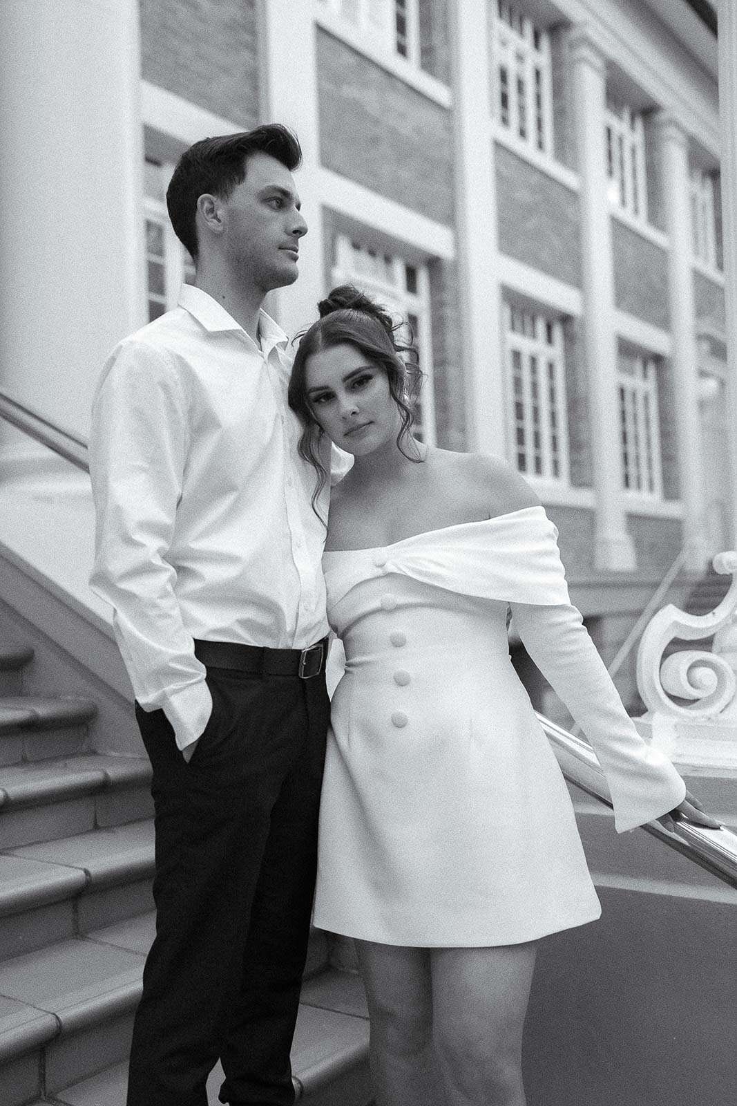 A couple poses on stairs in Brisbane city