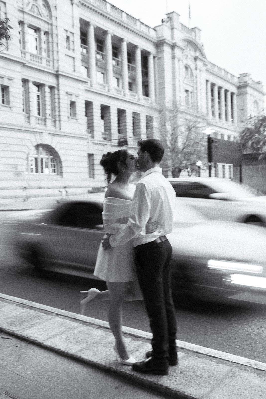 A couple posing for a photo in the city with motion blur