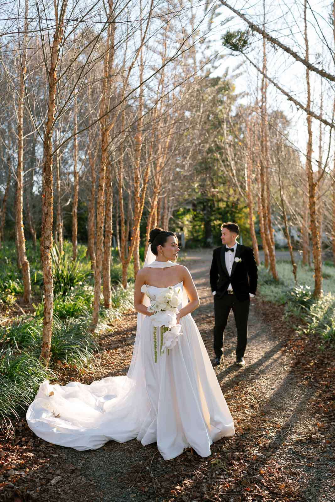 Bride and groom walking together in a hinterland wedding setting