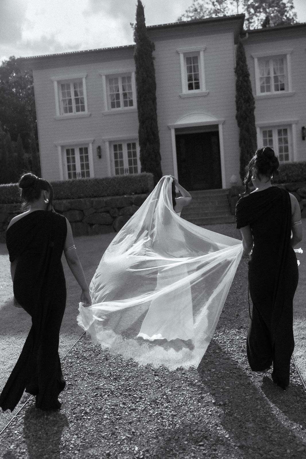 Bride walking with veil during a wedding at Wynmere Estate