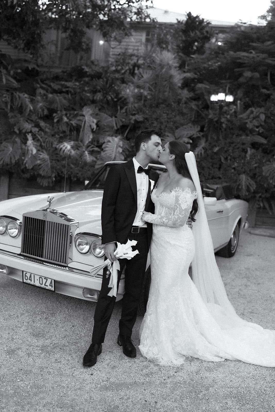 bride and groom pose infront of their wedding car at braeside estate